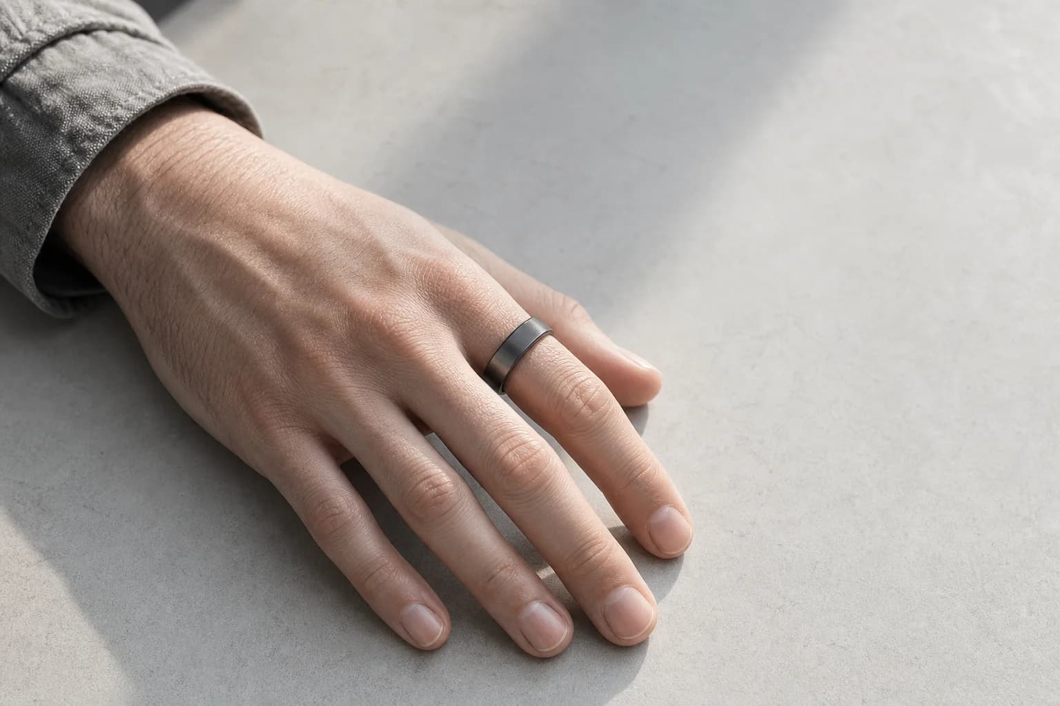 A hand at rest wearing the ORYN smart ring